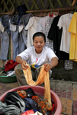 Cambodia girl washing clothes, phnom penh.