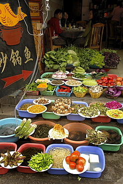 China display of fresh vegetables outsdie a restaurant dali town, yunnan province.