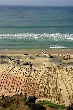 India fishermen arranging their nets on the beach. Varkala beach resort, kerala.