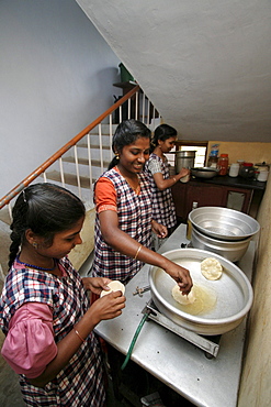 India queens garments, a project for poor women run by the congregation of the mother of carmel (cmc) sisters, kottayam, kerala. The young women serving and eating lunch, which they prepare themselves.