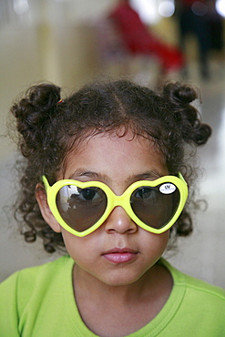 Honduras girl with sunglasses. slum barrio of chamelecon, pedro sula