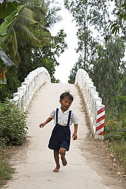 Vietnam hoa binh commune in vinh long province. this bidge across a river and next tohoa binh primary school, was constructed by crs (catholic relief services) to help the kids get to their classes. previously many of them had to walk several miles in order to attend school