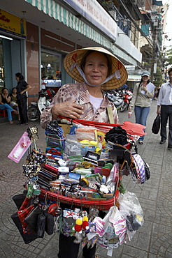 Vietnam saigon street trader selling a large range of everyday items