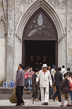 Vietnam notre dame cathedral, hanoi. worshippers leaving after sunday mass