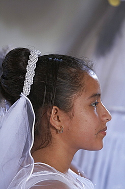 Guatemala catholic first communion and mass at remate, el peten. girl waiting to give first confession