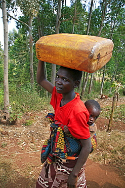 Burundi woman and her son carrying water from a stand pipe located 300 metres from their home.