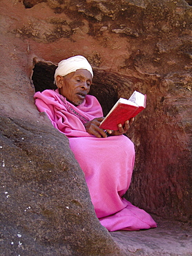 Religion, ethiopia. Monk (in pink, abba gebra kidan) staying in the caves near the churches of lalibela