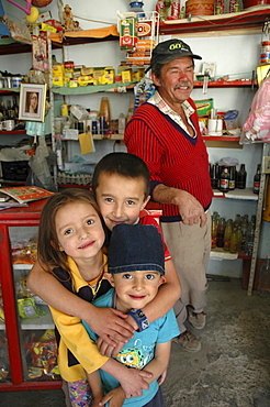 Colombia children with grandfather and his shop, altos de cazuca, bogota