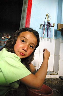 Colombia marly juliet, 7, of the slum of altos de cazuca, bogota, washing her face