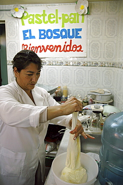 Colombia woman preparing dough for making bread at a bakery in ciudad bolivar, bogota