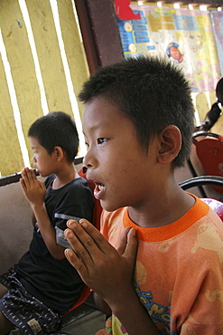 Thailand buddhist children praying at damanaruk childrens village