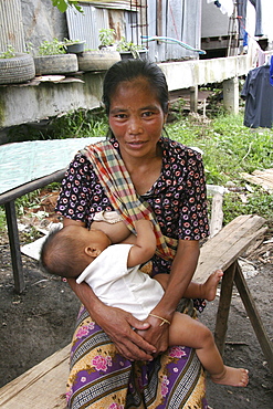 Thailand mother breast feeding baby. Inhabitants of a slum in chiang mai