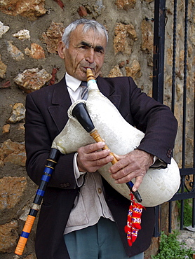 Macedonia (the former yugoslav republic of macedonia, fyrm) man playing bagpipes. The town of ohrid on the shore of lake ohrid