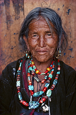 Torpu eppi. Every line in work-worn face tells a story. In mountains, is a sign of wisdom in of survival. Torpu eppi wears heirloom necklaces of coral, amber, turquoise, acquired on trading trips to tibet humla, north-west nepal 