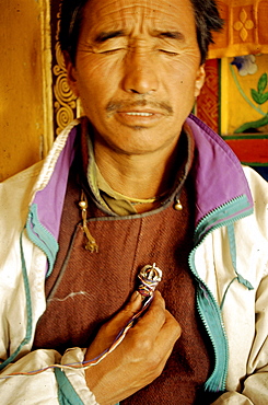 N month of november 7 days before full moon a sacred ceremony is held in various monasteries throughout himalayas by traditional healers known as amchis. They bring their precious herbs, minerals special animal glands to be blessed. A selected amount of herbs is placed in a copper vessel placed on monastery alter. 7 days amchis go through an elaborate potenization of these medicines through prayer other practices. Seen here is of amchis holding a dorje (sacred object used cutting through obscurations) which is lined from a vessel containing various herbs sitting on monastery alter to heart chakra. Chang tang nyee, ladakh, indi