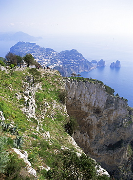 Distant Capri village and Faraglioni Rocks, from Mount Solare, the highest point on the island of Capri, Campania, Italy, Mediterranean, Europe