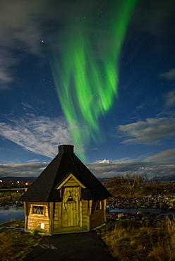 Aurora borealis over lakeside Kota (hut), Kilpisjarvi, Northwest Finland, Lapland, Finland, Scandinavia, Europe