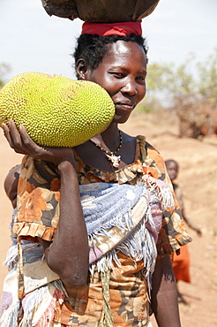 Woman holding a jack fruit, Lira, Uganda, Africa