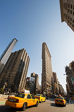 Flat Iron Building and yellow cabs at the intersection of 5th Avenue and Broadway, New York, United States of America, North America