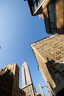 Looking up through skyscrapers at the Empire State, New York, United States of America, North America