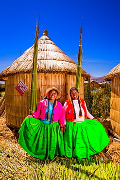 Two Quechua Indian women on Floating Grass islands of Uros, Lake Titicaca, Peru, South America