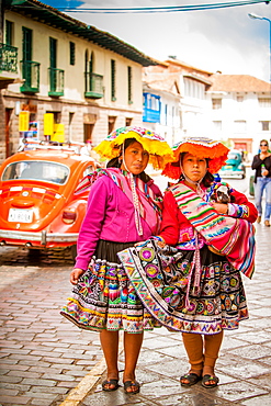 Two Cholita Peruvian girls and their lambs, Cusco, Peru, South America