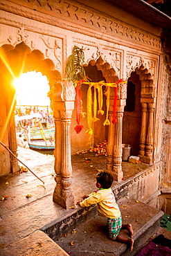 Little Indian boy watching the Traditional Krishna and Radha dance during the Flower Holi Festival, Vrindavan, Uttar Pradesh, India, Asia