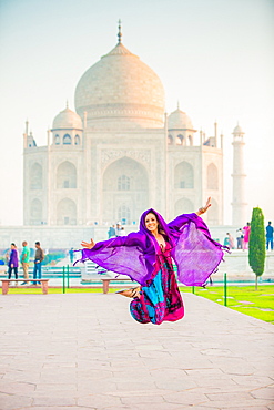 Laura Grier jumping at the Taj Mahal, UNESCO World Heritage Site, Agra, Uttar Pradesh, India, Asia