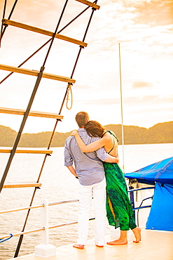 Couple enjoying the sunset on the Palau Siren, Koror Island, Palau, Micronesia, Pacific