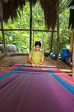 A woman weaves traditional fabric using a hand loom, Chittagong Hill Tracts, Bangladesh, Asia