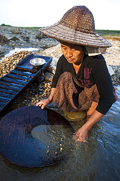 A Burmese woman panning for gold in a small stream near Putao in the north, Kachin State, Myanmar (Burma), Asia