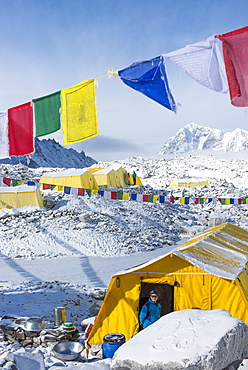 Prayer flags and the Everest base camp at the end of the Khumbu glacier that lies at 5350m, Himalayas, Nepal, Asia