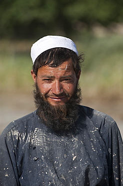 Afghani farmer from Herat Province takes a break from working in rice paddies to smile for the camera, Afghanistan, Asia