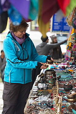 Shopping for souvenirs in Namche Bazaar, the main town during the Everest base camp trek, Khumbu Region, Nepal, Asia