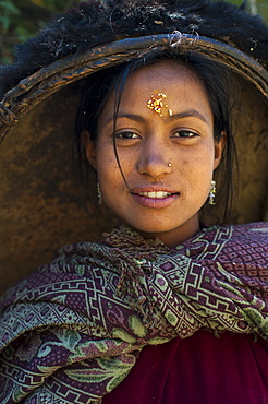 A striking looking woman from the remote Dolpa region carrying her rice pan on her head, Dolpa, Nepal, Asia