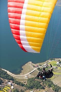 Paragliders make their way to the landing zone next to Phewa Lake, Nepal, Asia