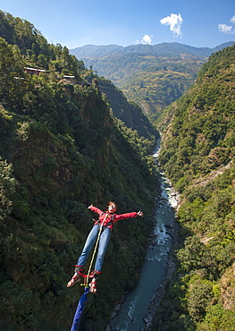 A girl jumps a bungy backwards, Nepal, Asia