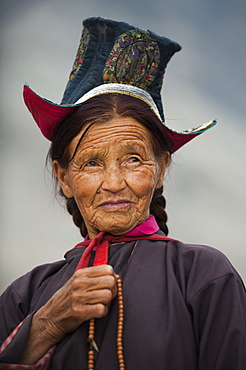 Buddhist woman travelling to a festival at the 14th-century Diskit Monastery, Ladakh, India, Asia