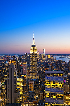 Manhattan skyline and Empire State Building at dusk, New York City, United States of America, North America