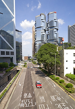 Red taxi cab in Central, Hong Kong Island, with the Bank of China Tower and Lippo Centre beyond, Hong Kong, China, Asia