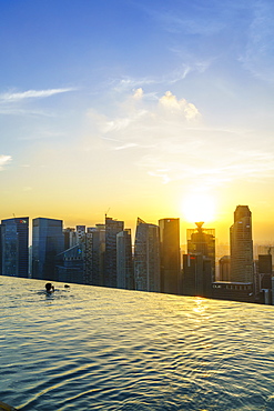 Infinity pool on the roof of the Marina Bay Sands Hotel with spectacular views over the Singapore skyline at sunset, Singapore, Southeast Asia, Asia