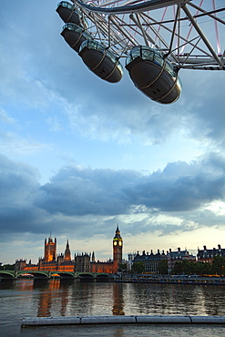 The Houses of Parliament and Big Ben at dusk from the South Bank of the River Thames with part of the London Eye in the foreground, London, England, United Kingdom, Europe