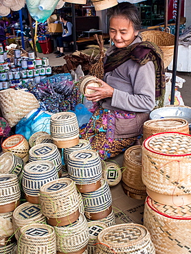 Woman selling baskets for sticky rice in central outdoor market, Luang Prabang, Laos, Indochina, Southeast Asia, Asia