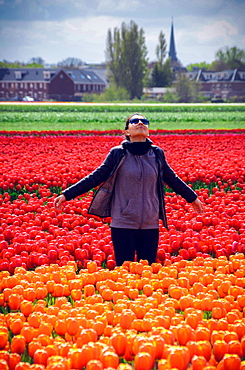 Young woman at tulip fields in Lisse, Netherlands, Europe