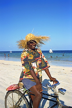 Cyclist with red snapper fish, Nyali Beach, Kenya, East Africa, Africa