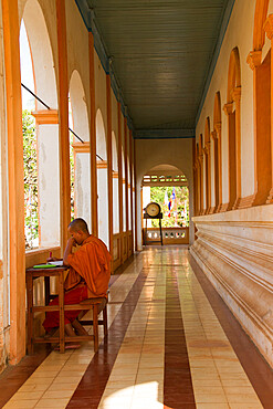 A Buddhist monk studies scripture in his temple of Wat Damnak, Siem Reap, Cambodia, Indochina, Southeast Asia, Asia