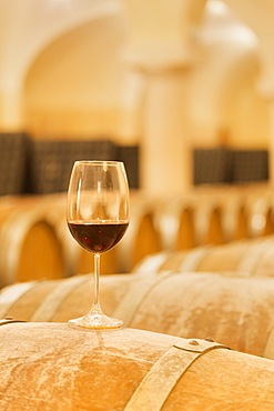 Wine glass on a wood barrel, Buglio in Monte, Valtellina, Lombardy, Italy, Europe