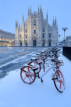 Parked bicycles covered by snow in Piazza Duomo, Milan, Lombardy, Northern Italy, Italy, Europe