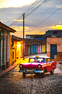 Vintage American taxi at dusk in Trinidad, UNESCO World Heritage Site, Sancti Spiritus, Cuba, West Indies, Central America