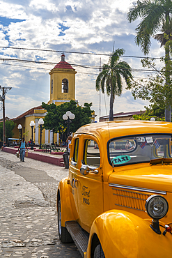 Yellow vintage taxi in Trinidad, UNESCO World Heritage Site, Trinidad, Cuba, West Indies, Caribbean, Central America